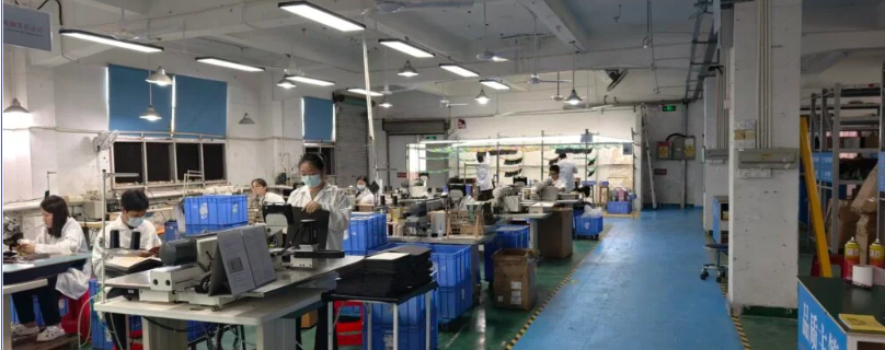 ZHIJIANG production floor supporting OEM hard shell case manufacturing, including material cutting, assembly preparation and final visual inspection.