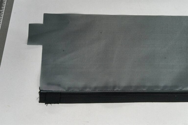 Zipper lining assembly inside a padded camera lens pouch