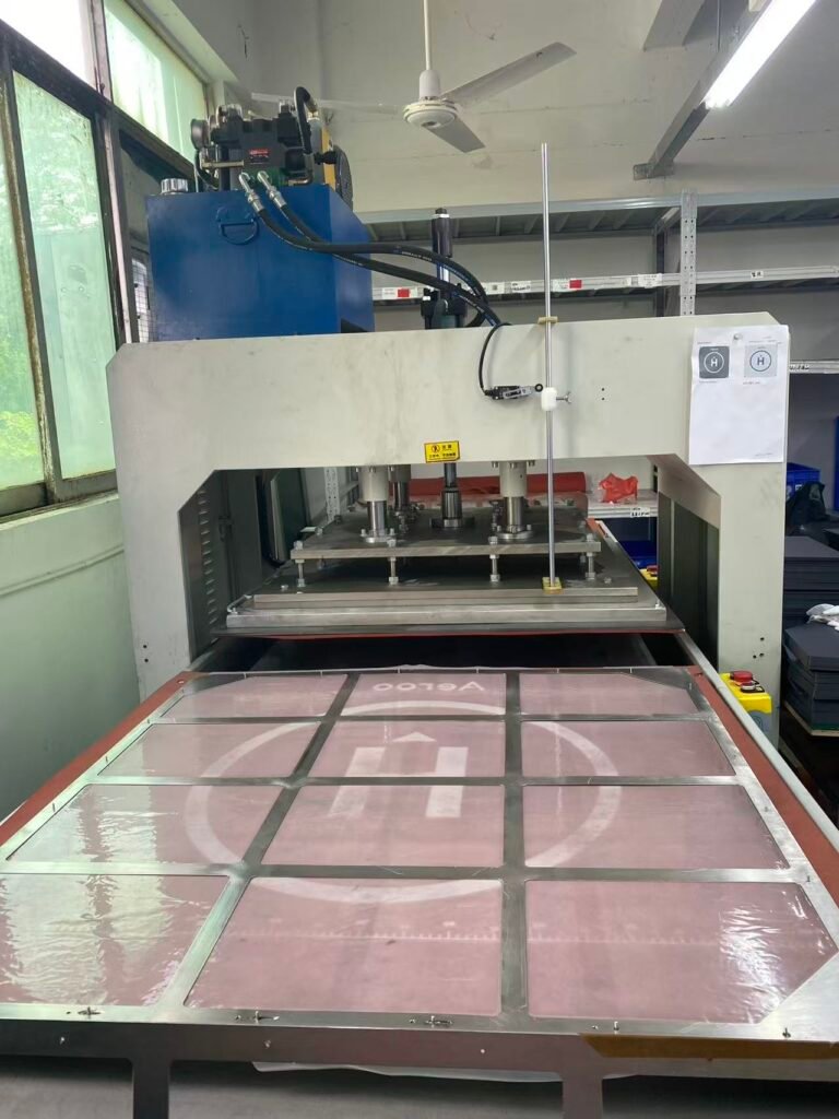 Industrial material cutting press inside a custom camera case OEM factory