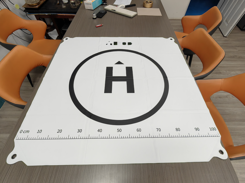 Factory team checking a printed drone landing pad for a custom drone carry kit
