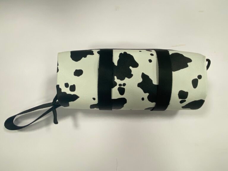 Finished black-and-white custom camera lens case sample with wrist strap