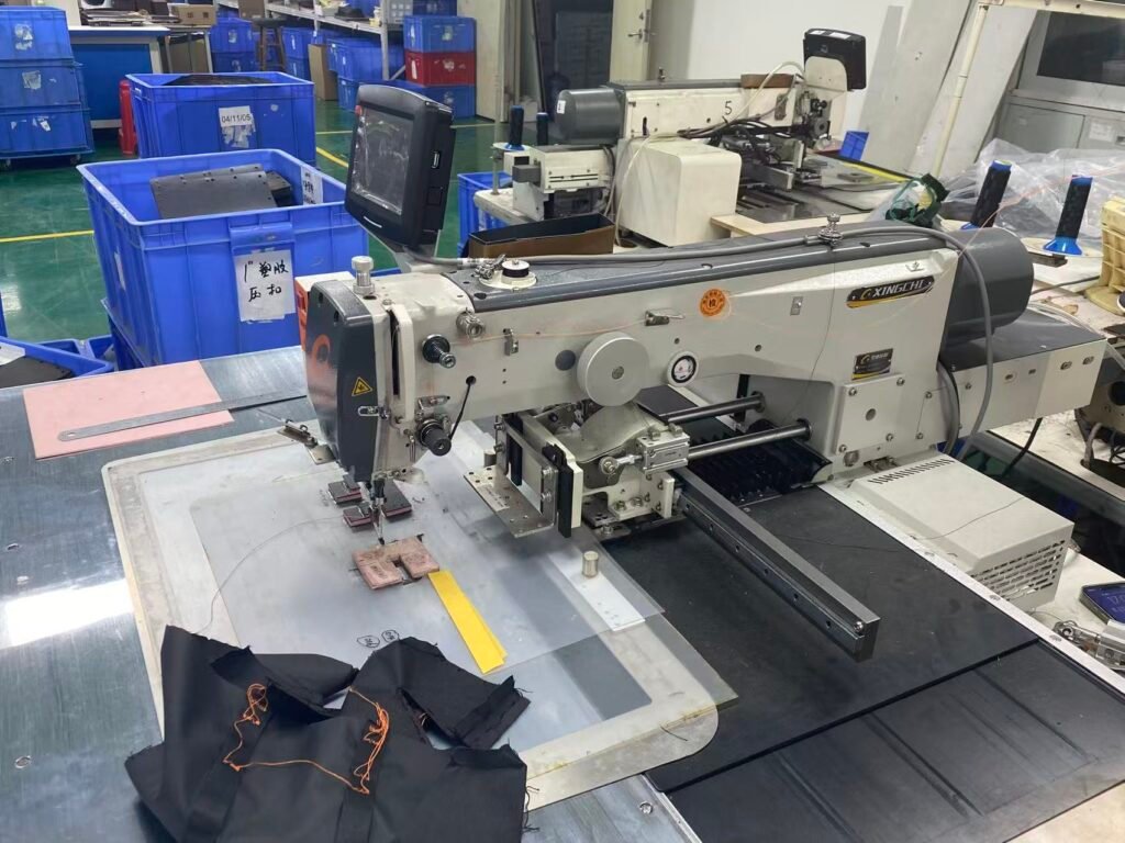 Industrial sewing machine assembling a custom camera case sample