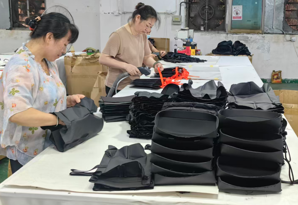 Finished camera case quality inspection for stitching edge finish and closure check