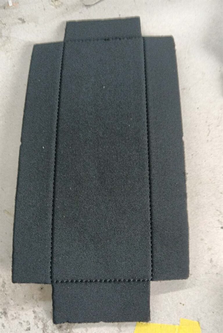 Black case panel with folded side sections during camera case assembly